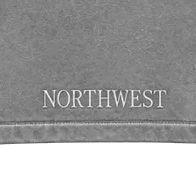 Close-up of the NORTHWEST wordmark stitched above the back hem band.