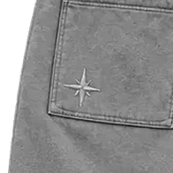Close-up of the compass stitched on the back patch pocket.