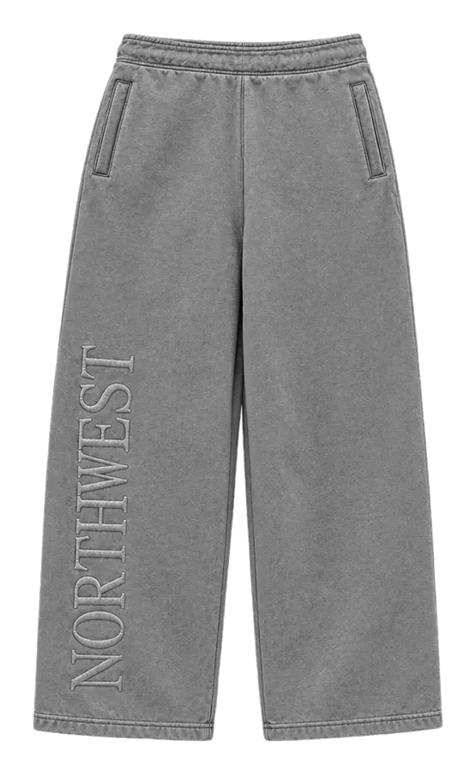 NORTHWEST wide-leg pants in washed grey, front view: elastic waist, welt side pockets and NORTHWEST stitched down the leg.